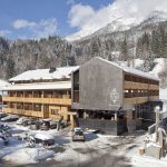 Oversized timber  gives the alpine  hotel a unique profile